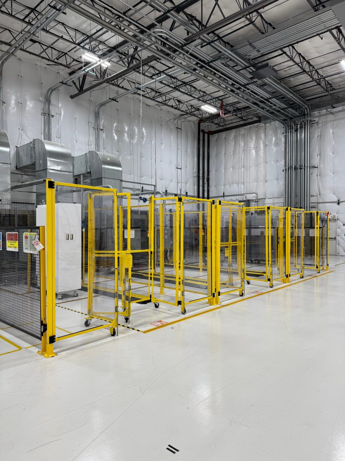 EV charger test cells behind safety fencing